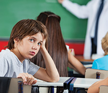 Tired child in classroom