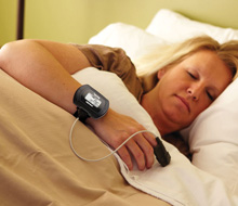 Woman sleeping with sleep study system in place