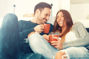 couple drinking coffee on the sofa
