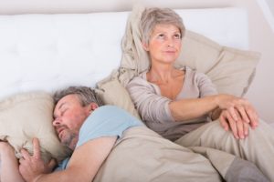 older man sleeping wife upset