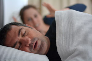 older man snoring while sleeping