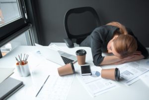 woman asleep at desk dealing with sleep apnea in Columbus