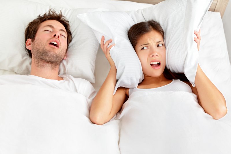 Man with sleep apnea sleeping next to partner