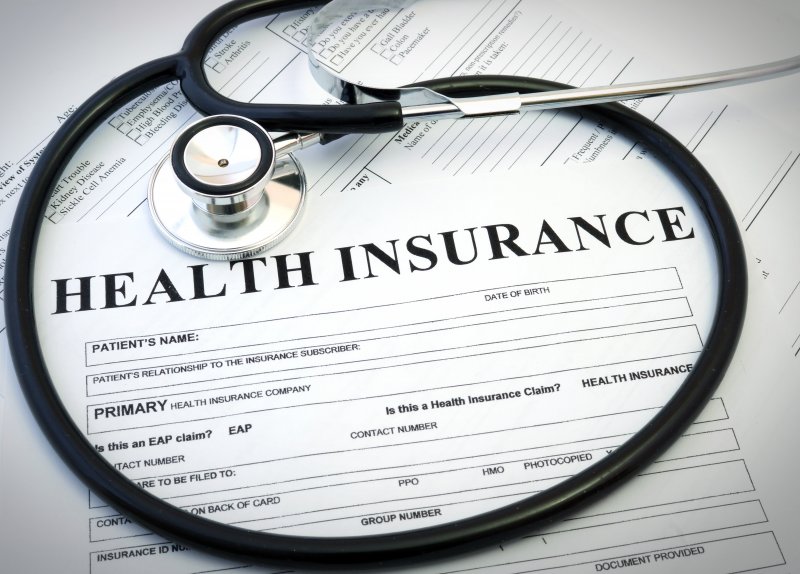 Stethoscope on top of a health insurance form