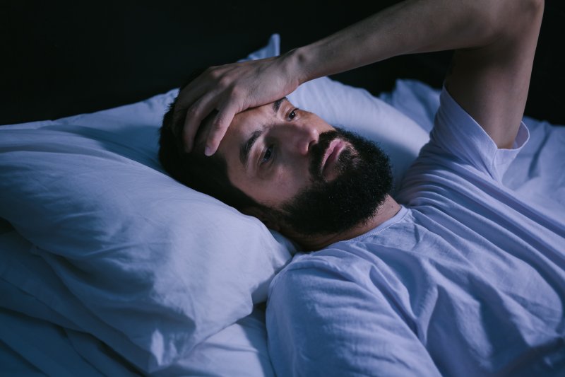 man with sleep apnea lying awake